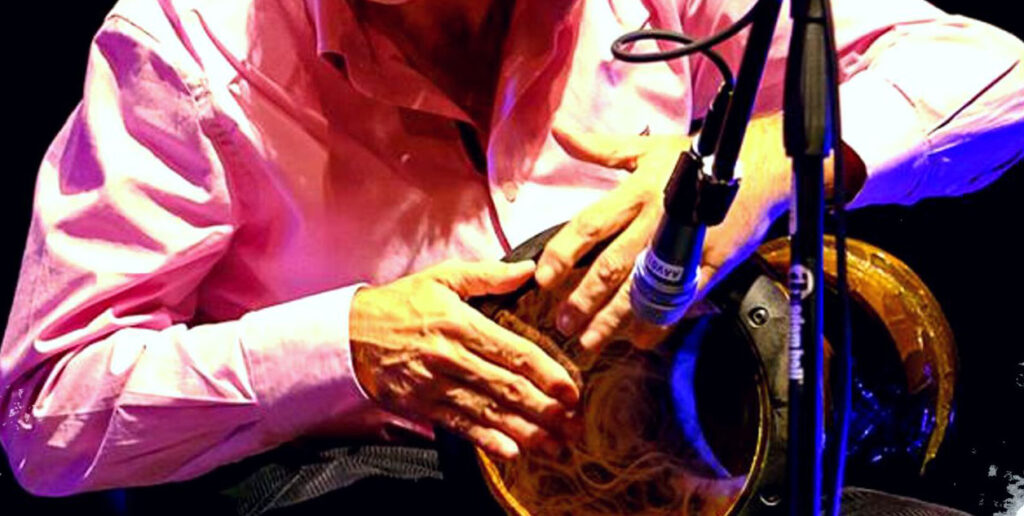 Musico a tocar instrumento de percussao
